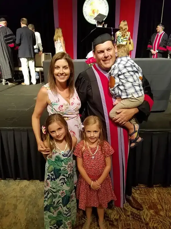 Dr. Copeland in academic wardrobe with his family