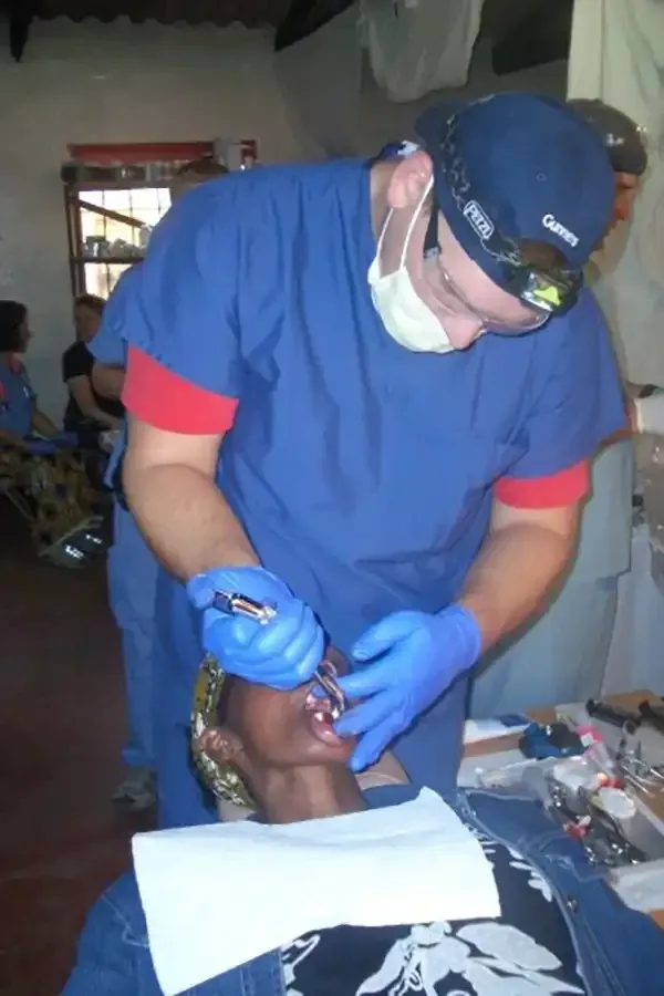 Dr. Copeland on a service trip to Latin America helping to remove teeth on patients in need